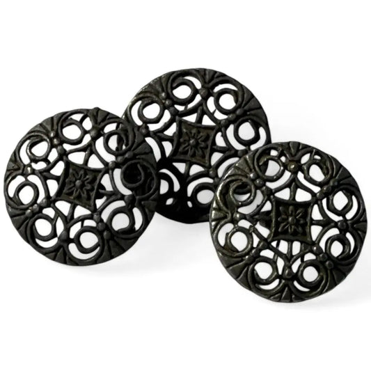 Three ornate black circular knobs.