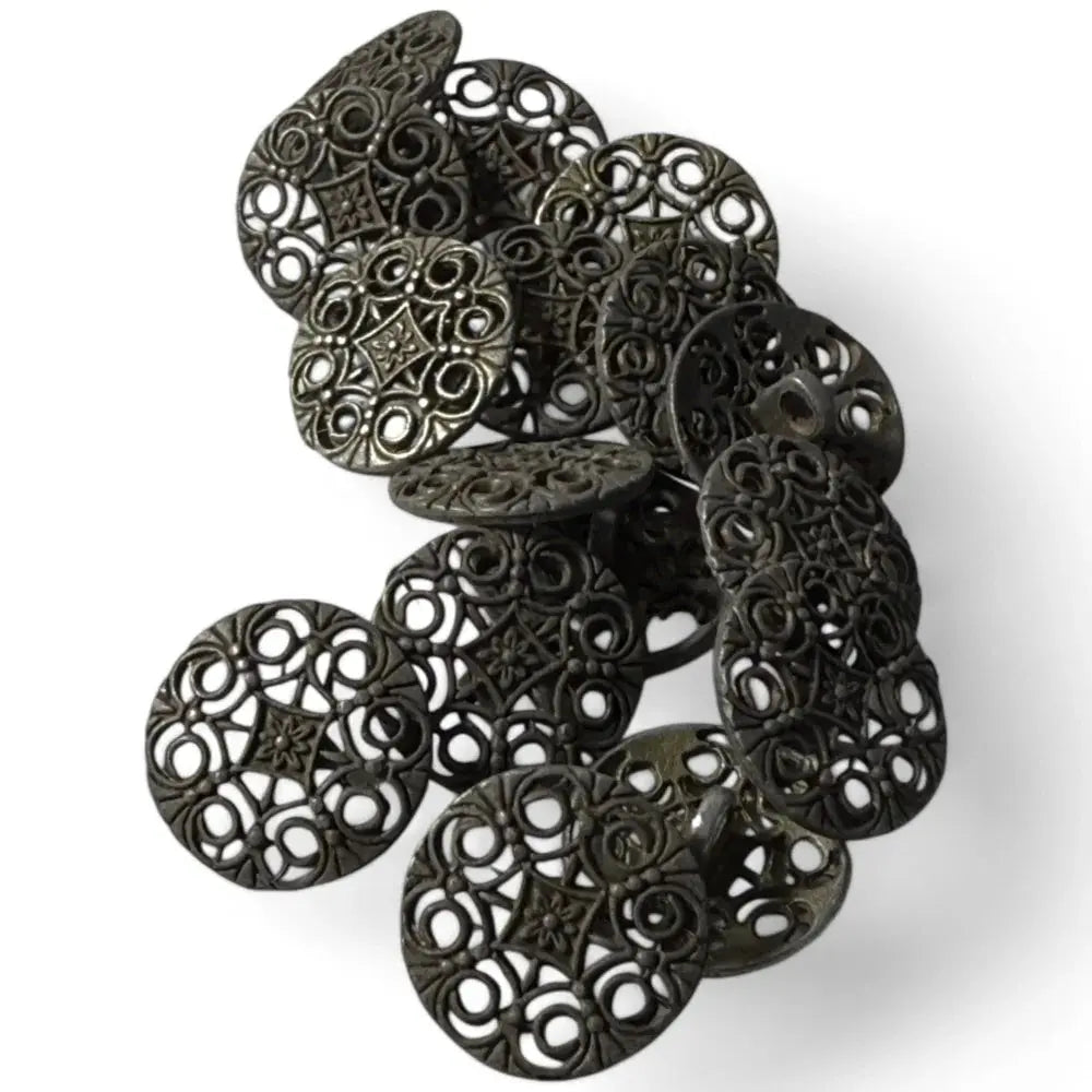 Pile of ornate, dark metal buttons.