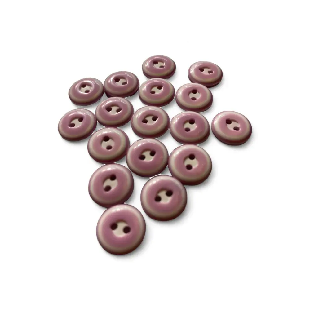 Pile of mauve two-hole buttons.