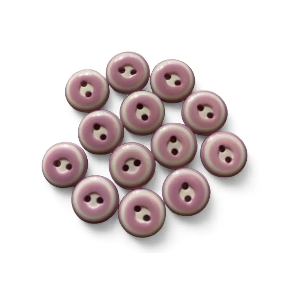 Pile of mauve two-hole buttons.