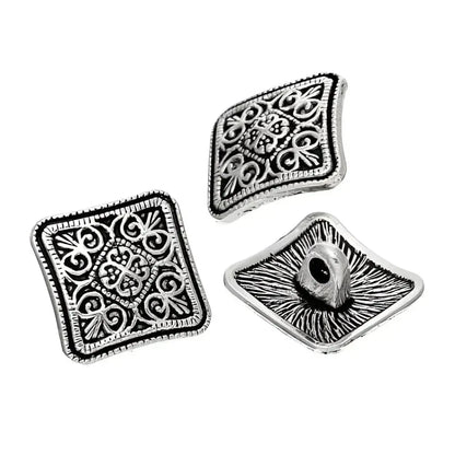 Three square, ornate, silver buttons.