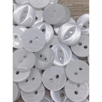 Pile of white two-hole buttons.
