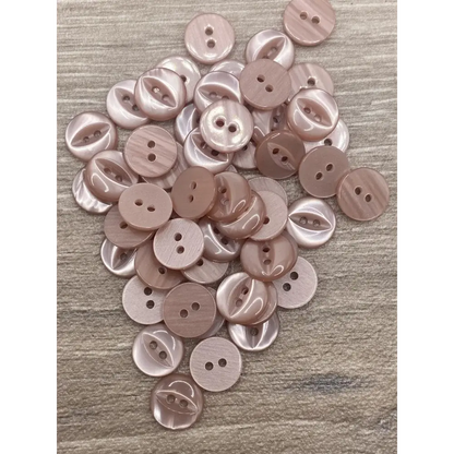 Pile of pink two-hole buttons.