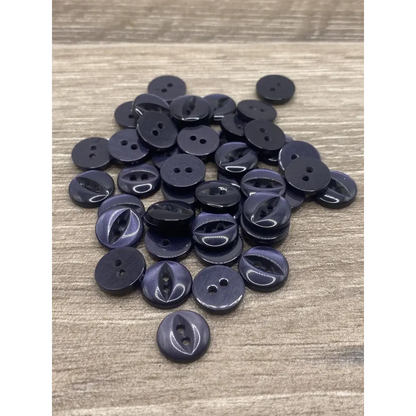 Pile of dark-colored, two-holed buttons.