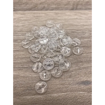 Pile of clear, two-hole buttons.