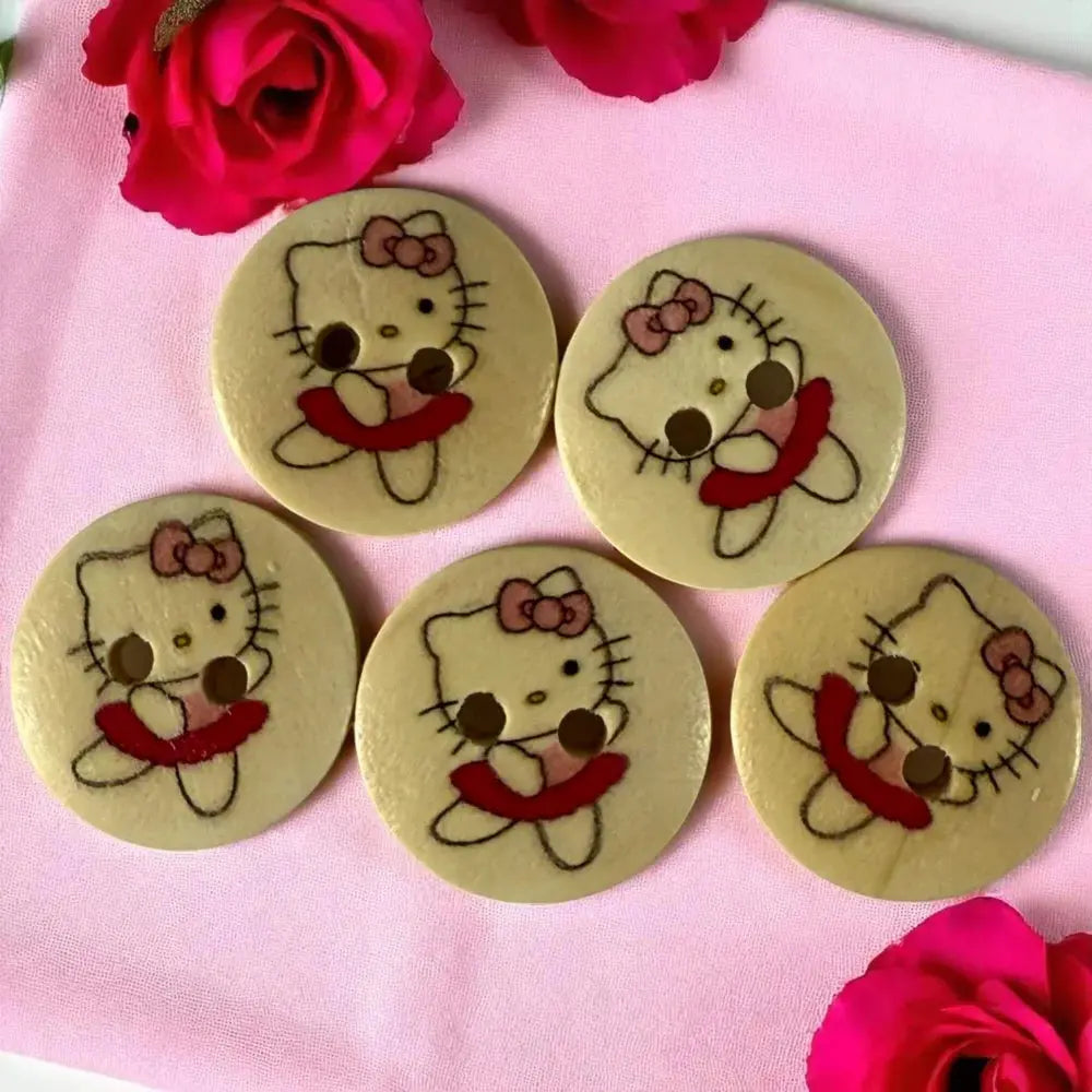 Five Hello Kitty buttons.
