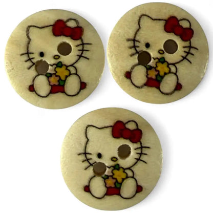 Three Hello Kitty buttons.