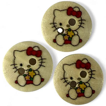 Three round Hello Kitty buttons.
