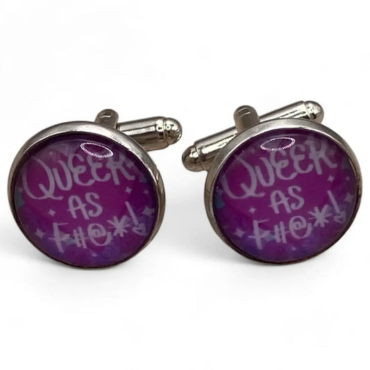 Pair of round cufflinks with purple background.