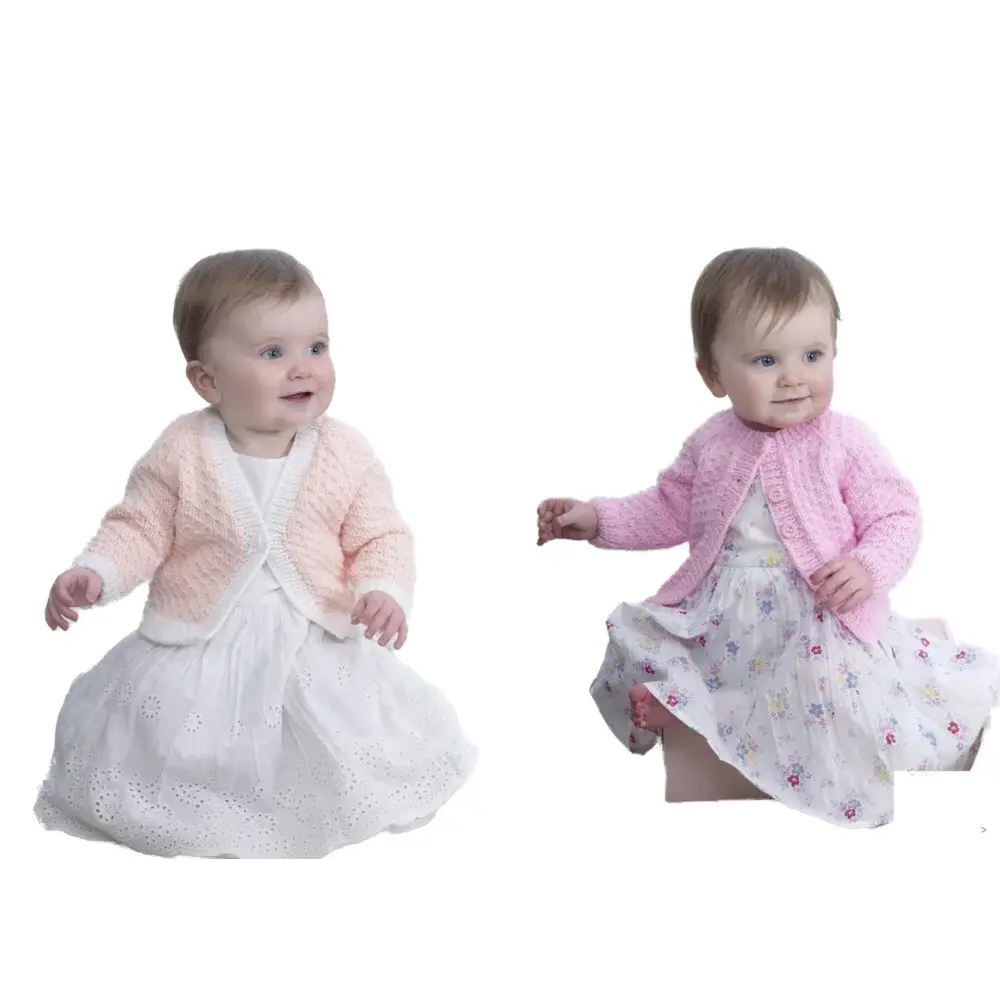 Two baby girls in dresses and cardigans.