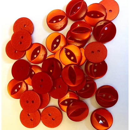 Pile of red and orange buttons.