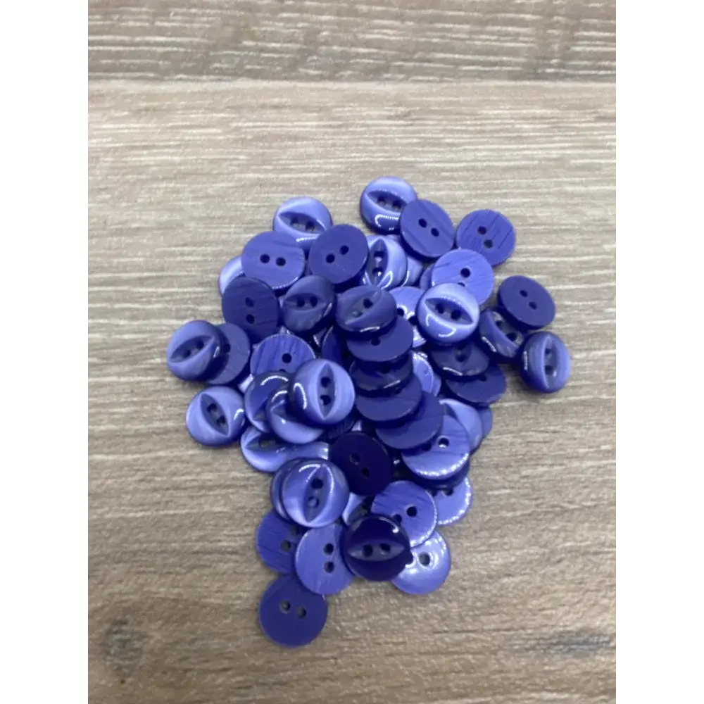 Pile of purple two-hole buttons.