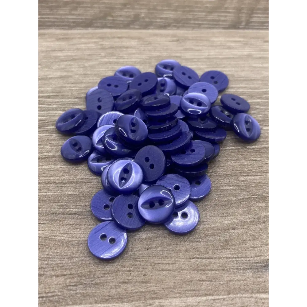 Pile of two-hole purple buttons.