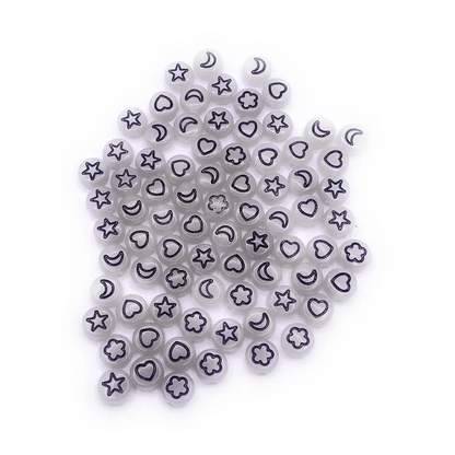 Translucent beads with black shapes.