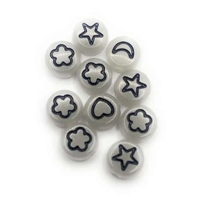 White beads with black shapes.