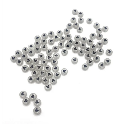 Translucent beads with black heart design.