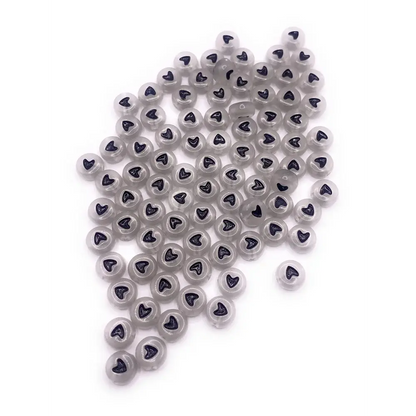 Pile of gray heart-printed beads.