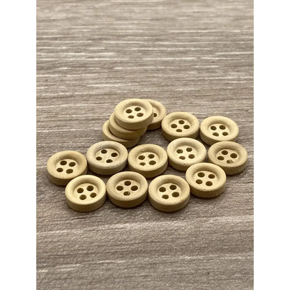 Pile of round, four-hole wooden buttons.