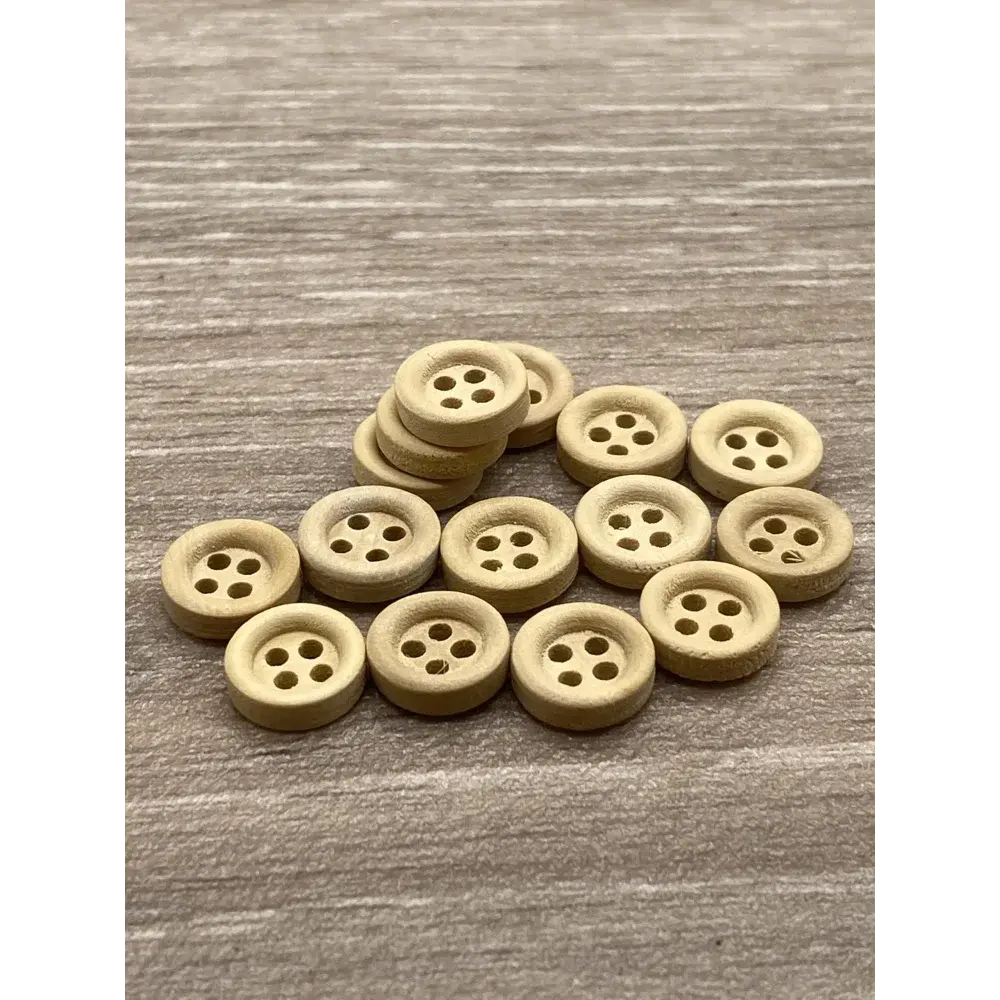 Pile of round, four-hole wooden buttons.