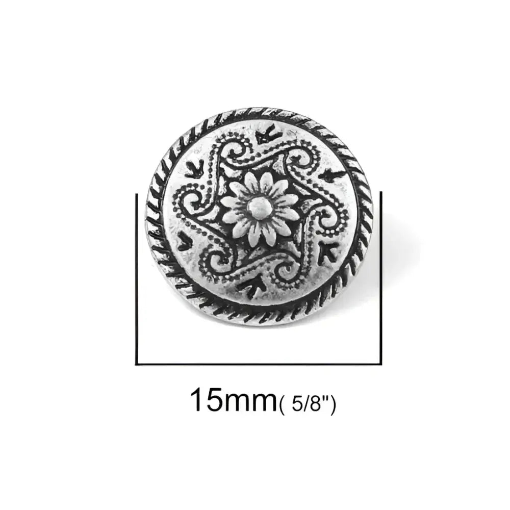 Ornate silver button.