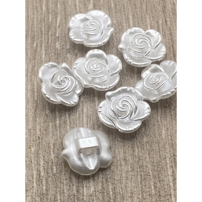 Silver rose-shaped buttons.