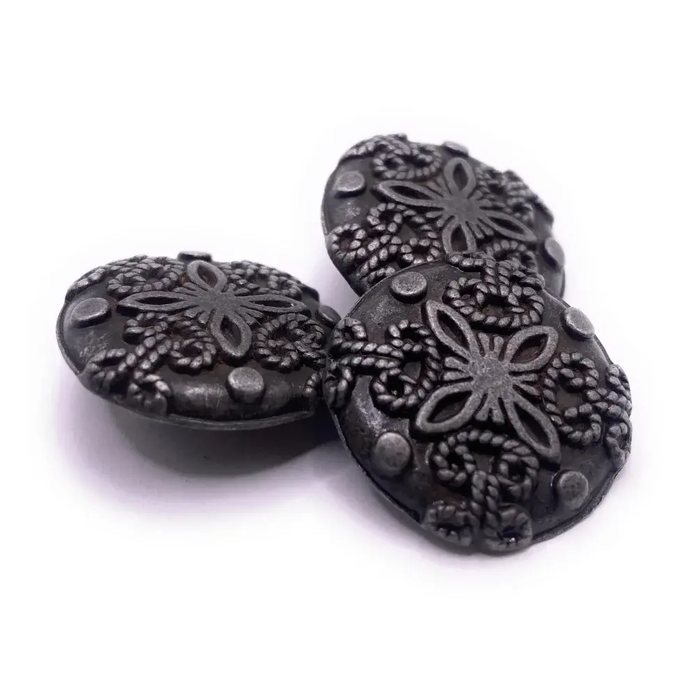Three decorative metal buttons.