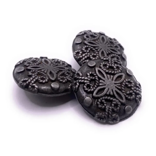 Three decorative metal buttons.
