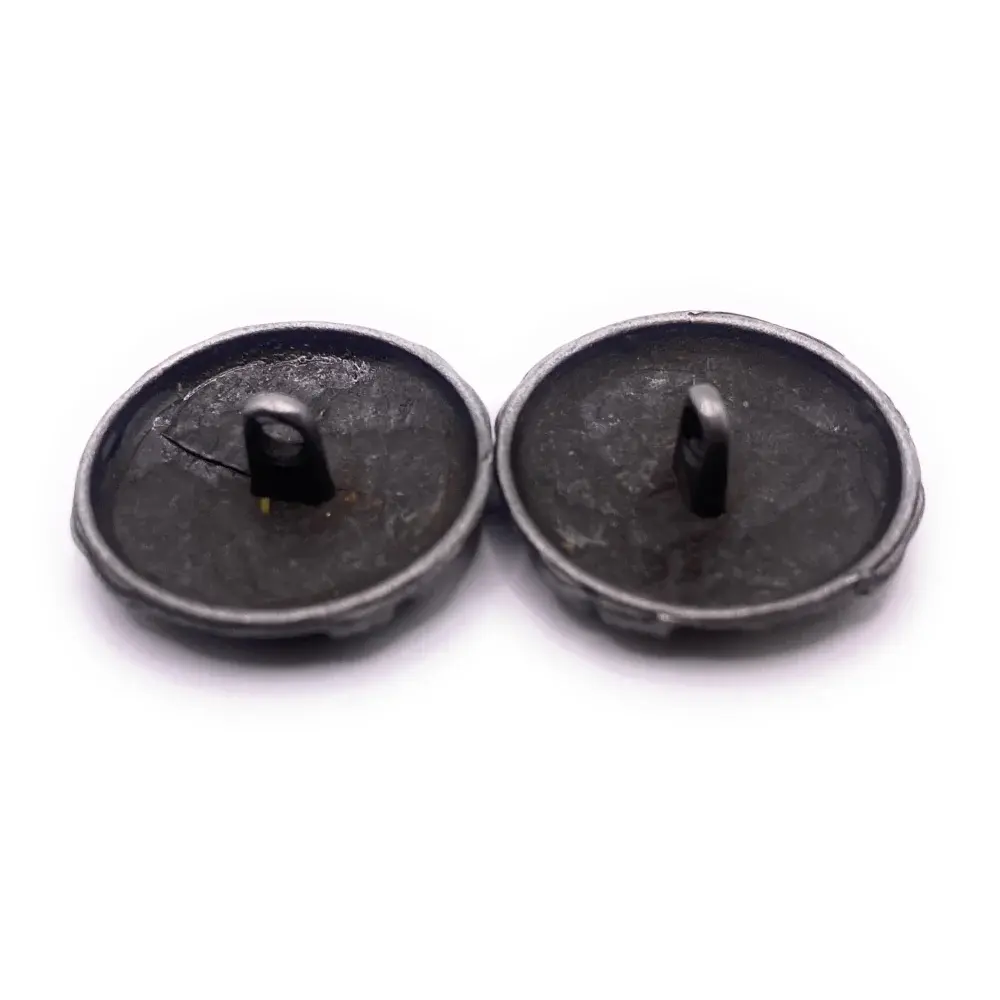 Two dark, metal shank buttons.