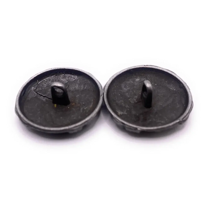 Two dark, metal shank buttons.