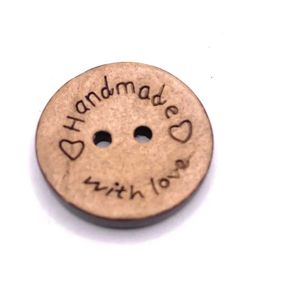 Round wooden button with ’handmade with love’ inscription.
