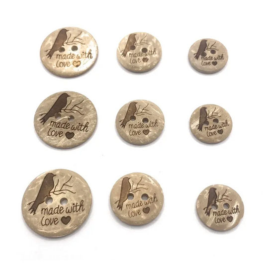 Nine round, beige buttons with a bird and ’made with love’ design.