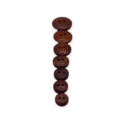 Stacked brown two-hole buttons.