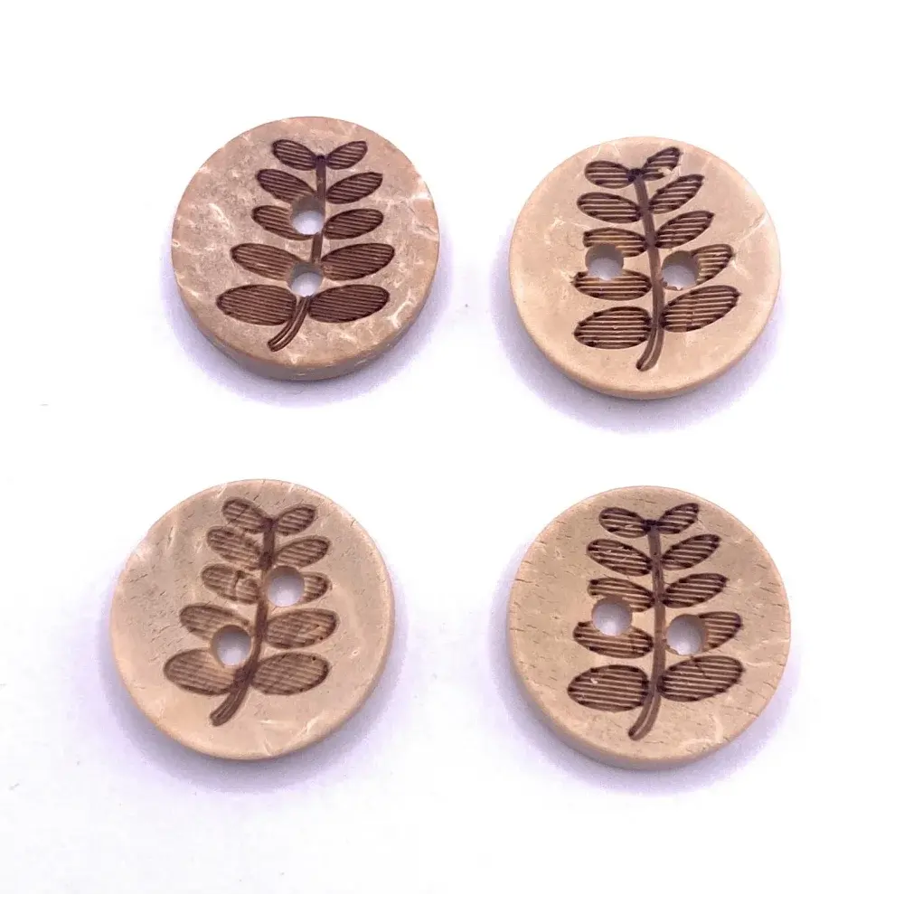 Four round wooden buttons with leaf design.