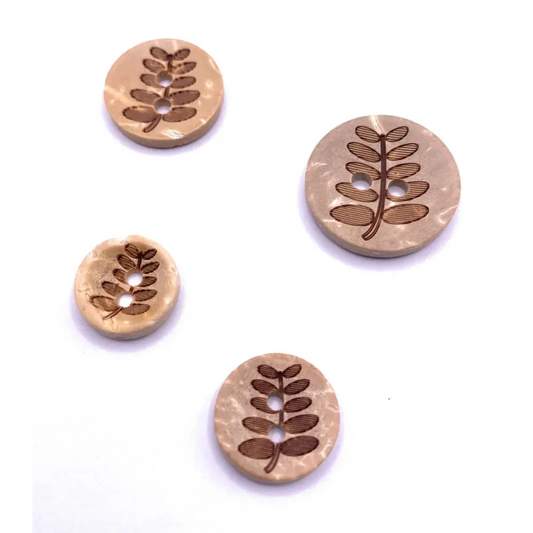Four round, wooden buttons with leaf design.
