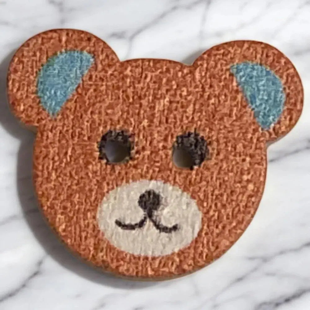 Brown teddy bear button.
