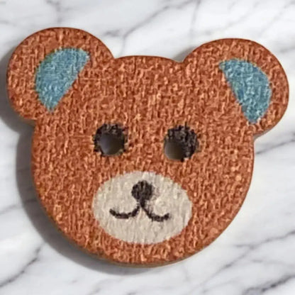 Brown teddy bear button.