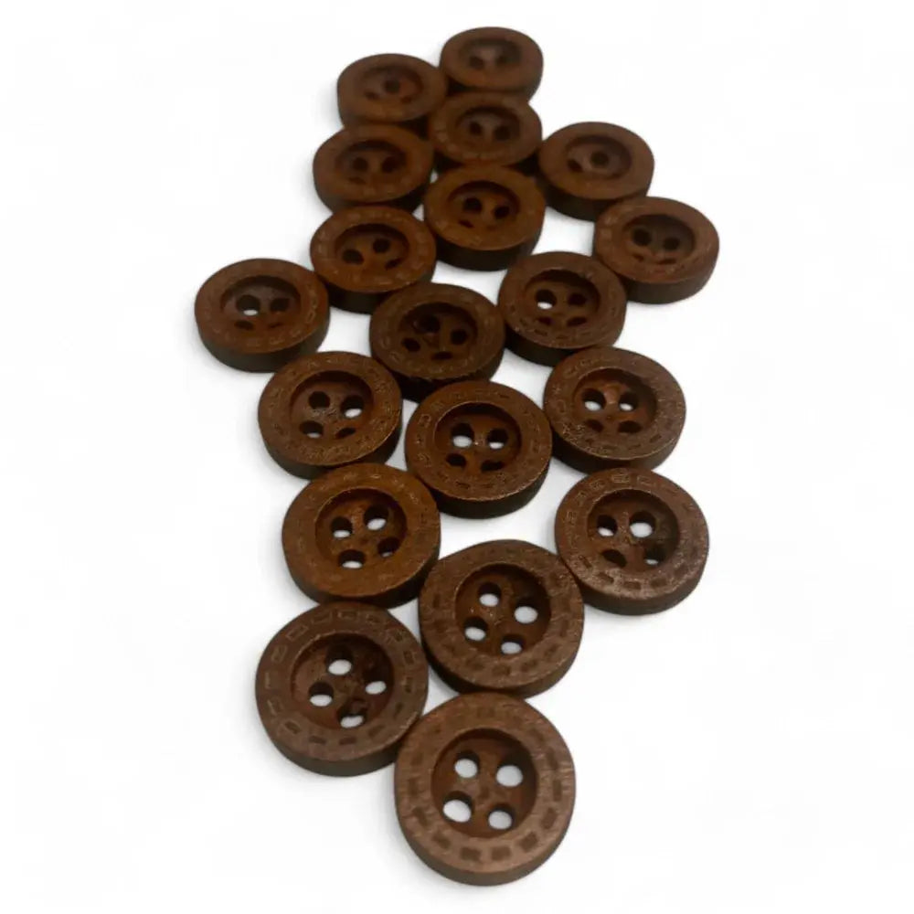 Pile of brown, round, patterned buttons.