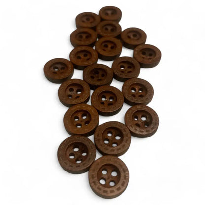 Pile of brown, round, patterned buttons.