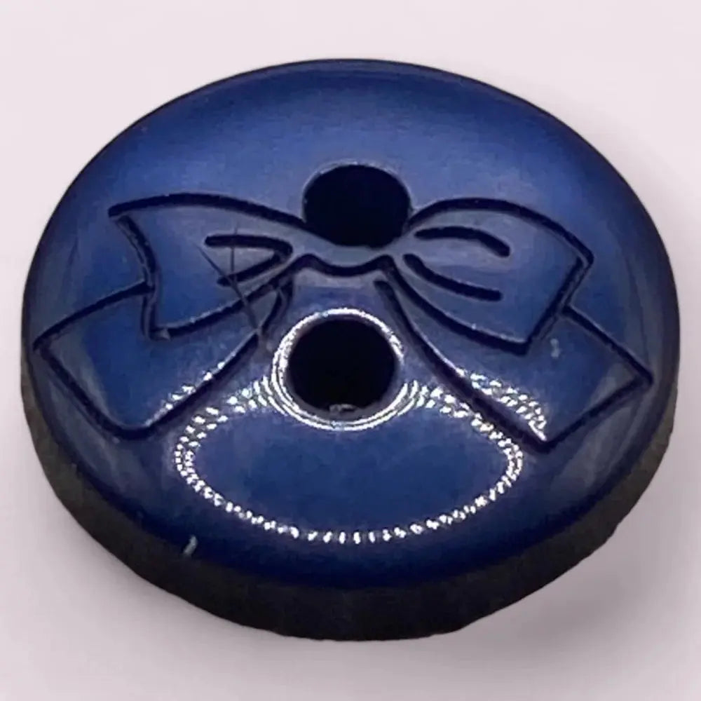 Blue button with a bow design.