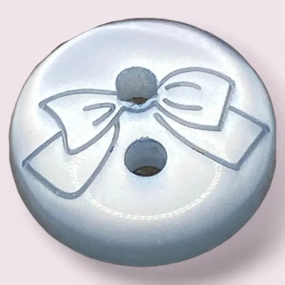 Round, light blue button with a bow design.