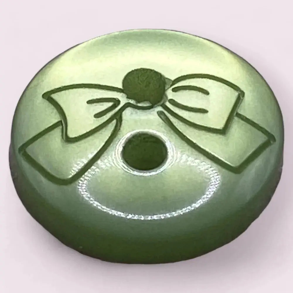 Green button with a bow design.