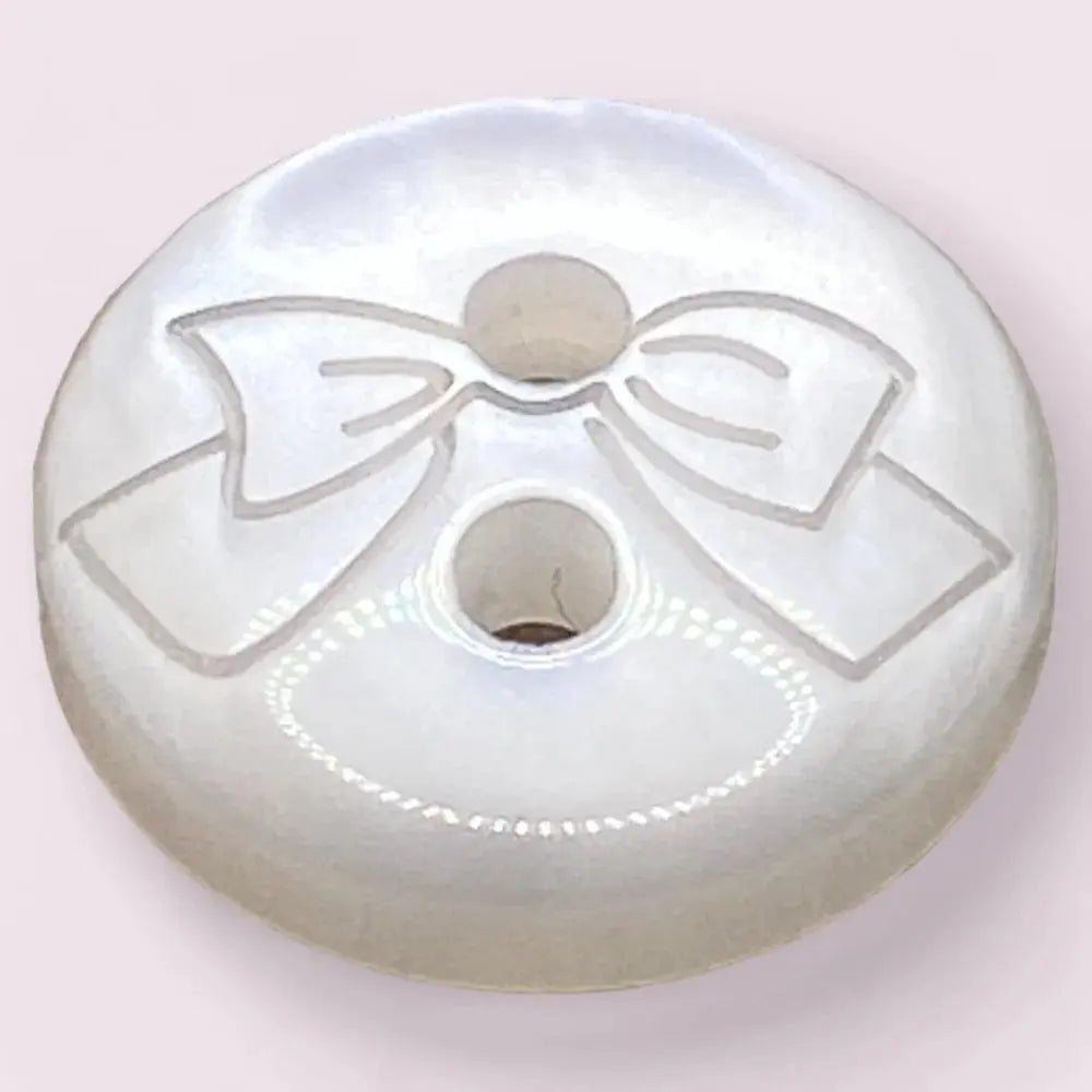 White button with a bow design.