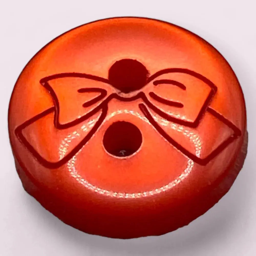 Orange button with a bow design.