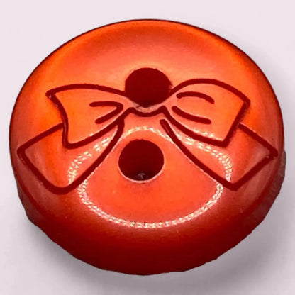 Orange button with a bow design.