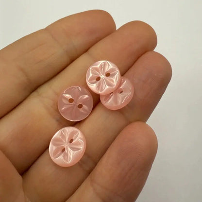Pale pink flower-shaped buttons.