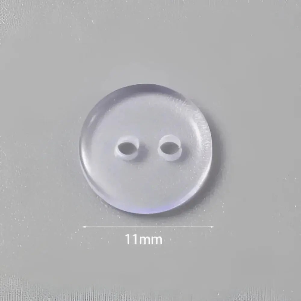 Clear, two-hole button.