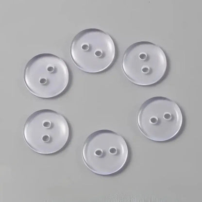 Six clear, two-hole buttons.