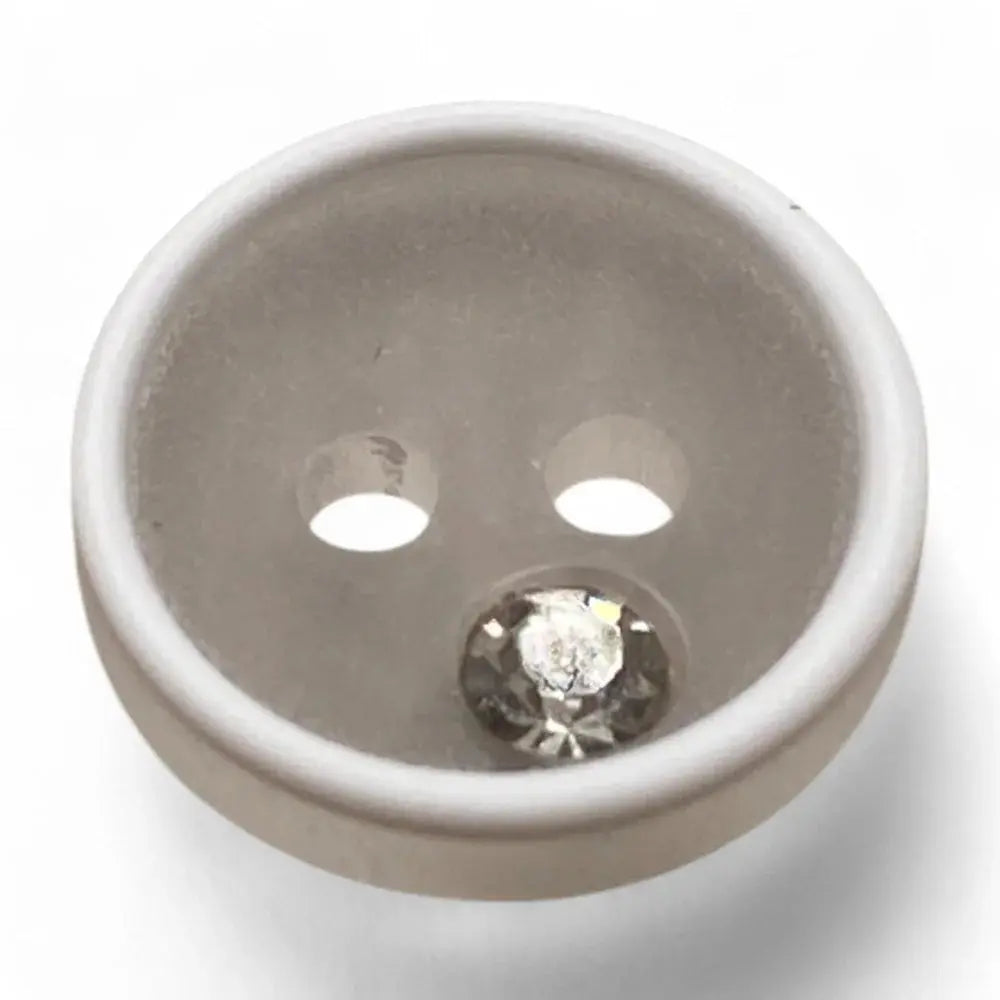 White button with a rhinestone.