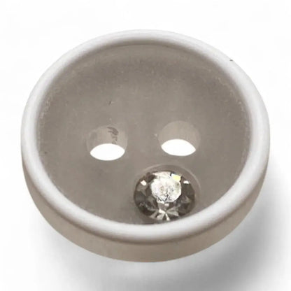 White button with a rhinestone.