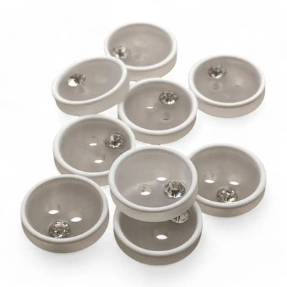 White buttons with embedded rhinestones.